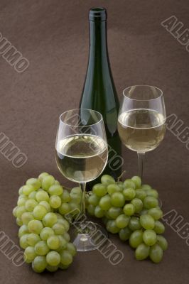 White wine with bottle, glasses and grapes