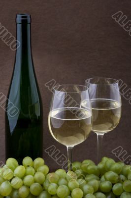 White wine with bottle, glasses and grapes
