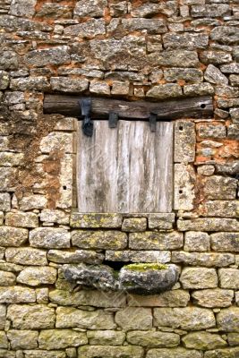 Old yellow stone wall with close window - 2