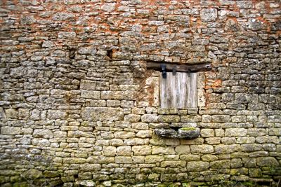Old yellow stone wall with close window - 3