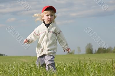 little girl on green meadow