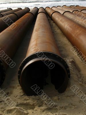 Construction pipes on the seashore