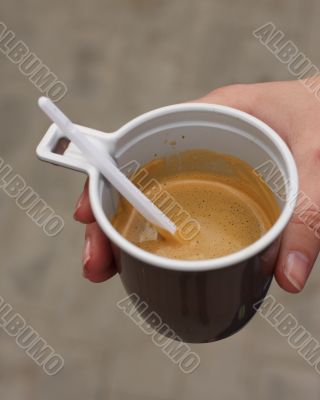 Hand of the girl with a coffee cup