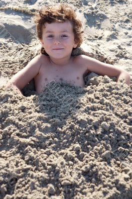 Child buried in the sand