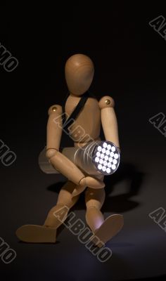 wood mannequin and flashlight