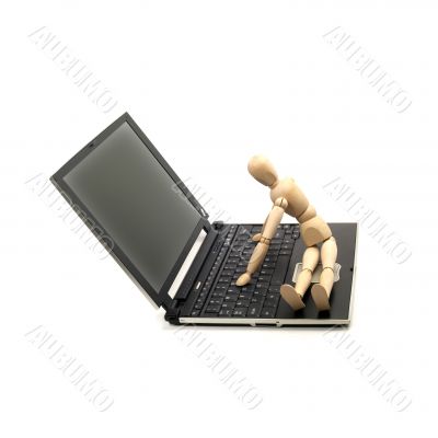 wood mannequin and laptop