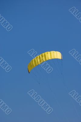 Yellow kite in the blue sky