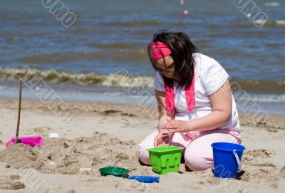 Girl Making Sand Castle