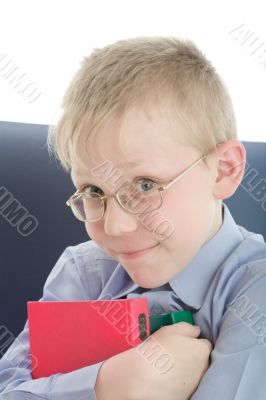 Boy in eyeglasses embrace three interesting books