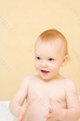 Enjoying baby stand on bed and clap hands