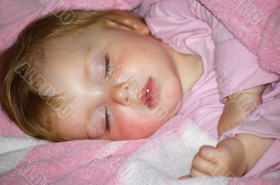 Beautiful girl in a pink sleeps