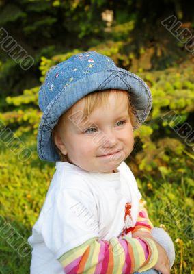 Small beautiful girl on a grass