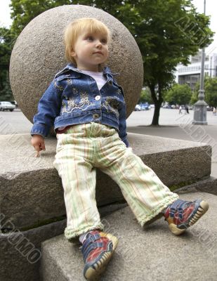 Girl sits near a sphere