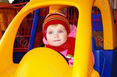 Little girl in the carriage  in a supermarket