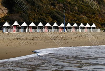 beach huts and incoming tide