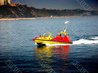 powerboat along the coast on a sunny day