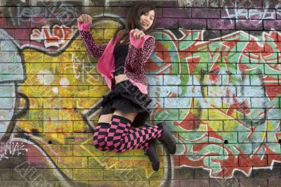 Teenager jumps before graffiti wall