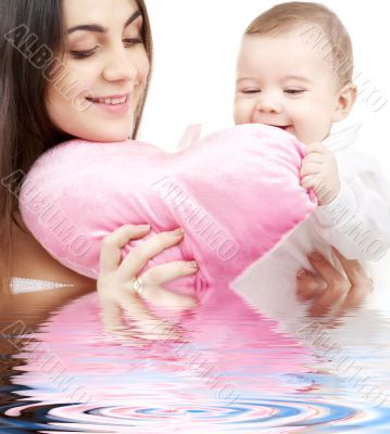 baby and mama with heart-shaped pillow