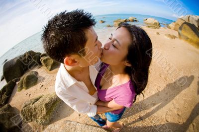 young couple kissing on the beach