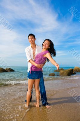 loving young couple hugging each other on the beach