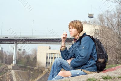 The sitting guy with a cigarette outdoor 2
