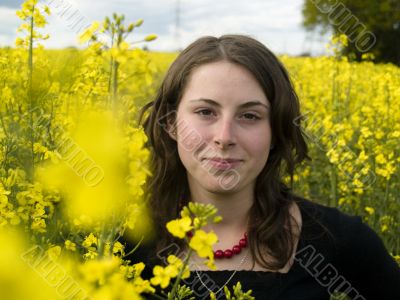 Yellow rape field and young girl