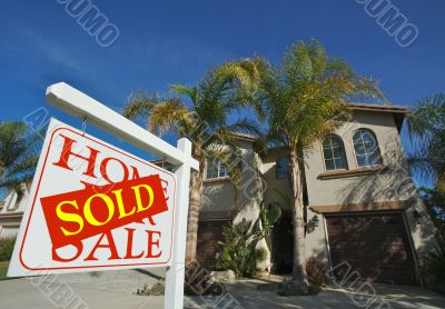 Sold Home For Sale Sign & New House