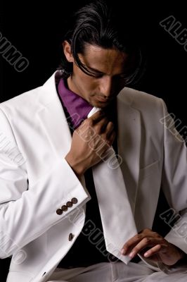 TYoung man with his necktie