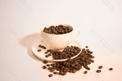 ceramic cup filled with coffee beans