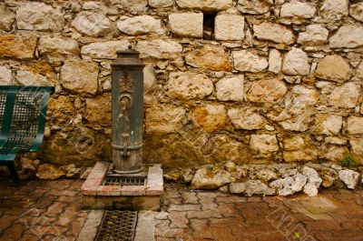 Ancient Brick Wall and Water Pump
