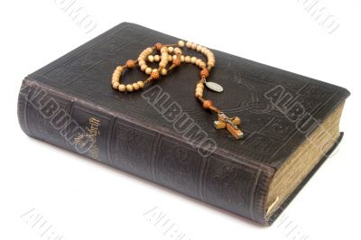 Ancient bible with rosary
