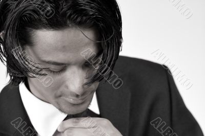 Young man is bussy with his necktie