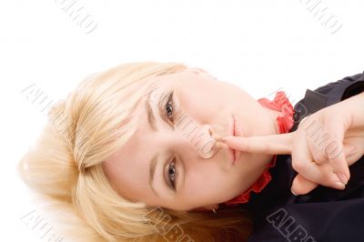 Beautiful blond girl show silence sign by finger on lip