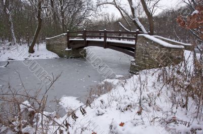 Beautiful Wooden Bridge Over Frozen Stream