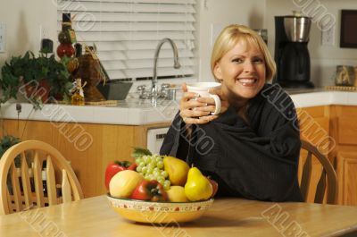 Woman In Kitchen with Cup of Coffee