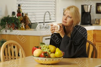 Woman in Kitchen with Cup of Coffee
