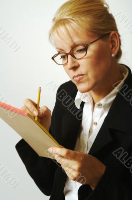 Beautiful Woman Thinks with Pencil & Notepad Taking Notes