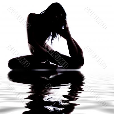Silhouette of a gymnast in the water