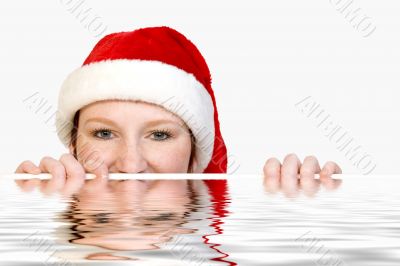 Christmas faerie looking over the edge of a pool
