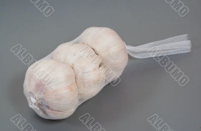 Three garlic bulbs in a net