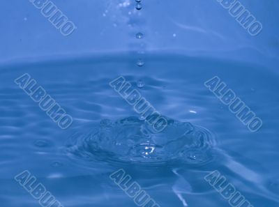 splash of blue water with small drops
