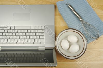 Laptop, eggs and mixer