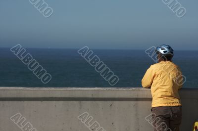 Bicyclist Rests Near Ocean