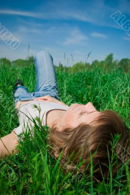 A beautiful young woman relaxing in the grass