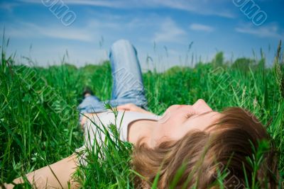 A beautiful young woman relaxing in the grass