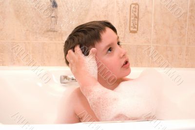 kid in a bathtub with foam