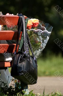 Handbag and bunch of flowers