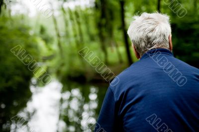 Older man overlooking a stream