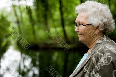 Grandmother standing near a stream