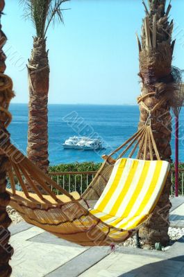 Hammock with the striped mattress against Red Sea